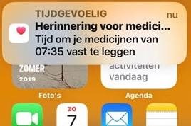 iPhone met melding om medicijnen in te nemen.
