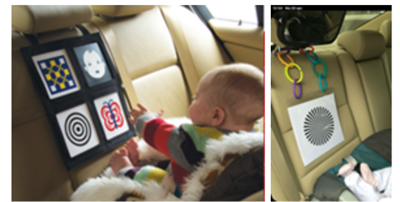 Baby kijkt plaatjes op de achterbank van de
auto