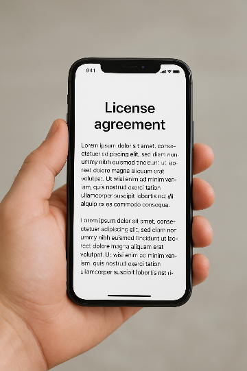 iphone in een hand met op het scherm de koptekst "License agreement". Deze
afbeelding is gemaakt met AI.
